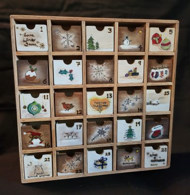 Festive advent cabinet - Traditional design idea. 
Measurements:
Outer: 35.5cm x 35.5cm
Each Drawer: 4.5cm x 5.5cm x 4cm